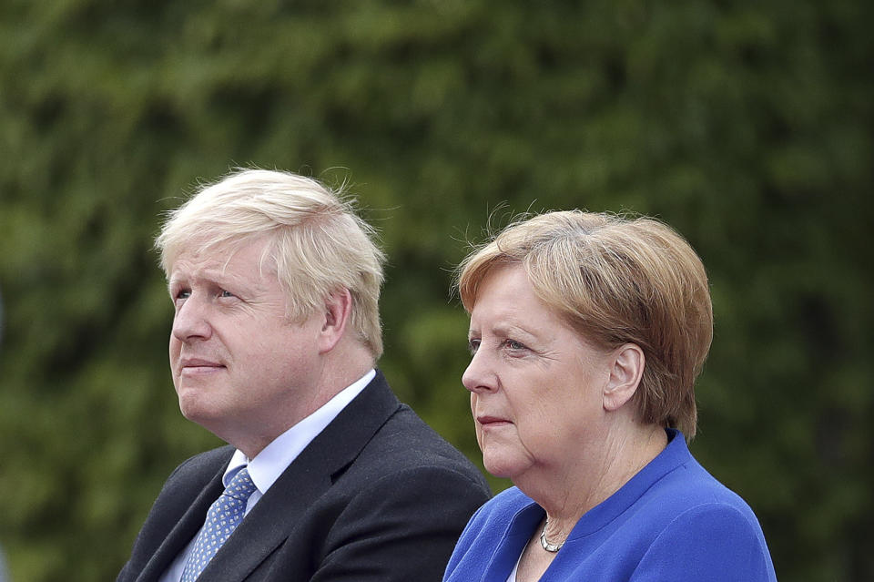 German Chancellor Angela Merkel welcomes Britain's Prime Minister Boris Johnson for a meeting at the Chancellery in Berlin, Germany, Wednesday, Aug. 21, 2019. (AP Photo/Michael Sohn)
