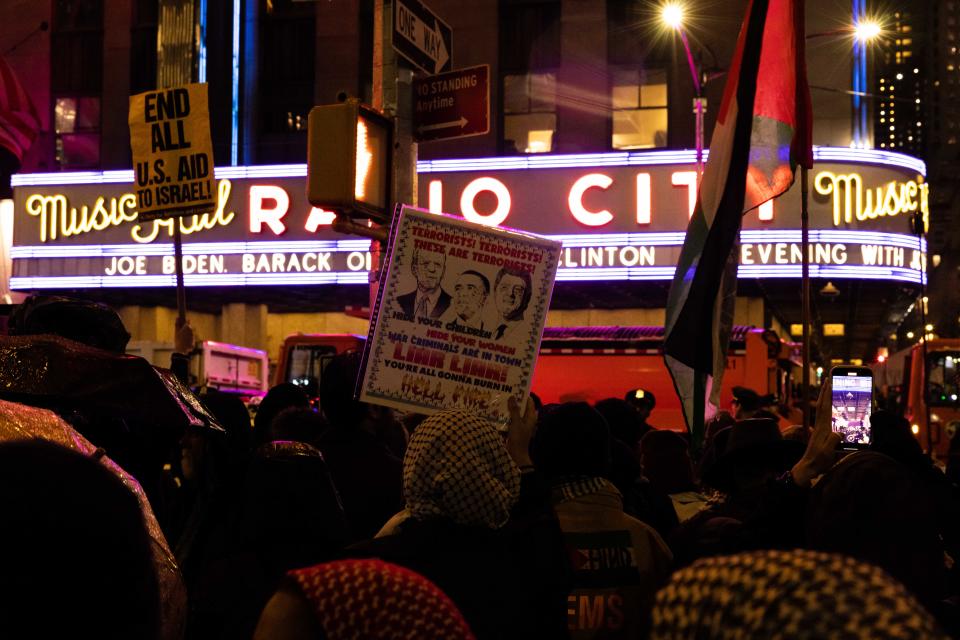 Pro-Palestinian demonstrators hold up a sign outside Radio City Music Hall during President Joe Biden's fundraiser on March 28, 2024 in New York City. Biden will be joined by former presidents Bill Clinton and Barack Obama at the fundraiser.