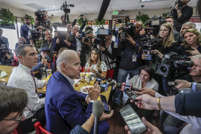 Presidential candidate Joe Biden and L.A. Mayor Eric Garcetti are swarmed by media during a visit to King Taco.