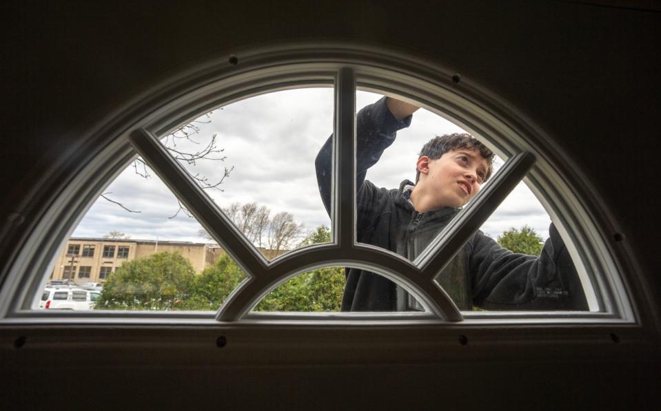 A student attaches siding to the tiny house being built at Milwaukee Jewish Day School on May 2. The house will be moved to Racine for veteran housing at the end of the semester.