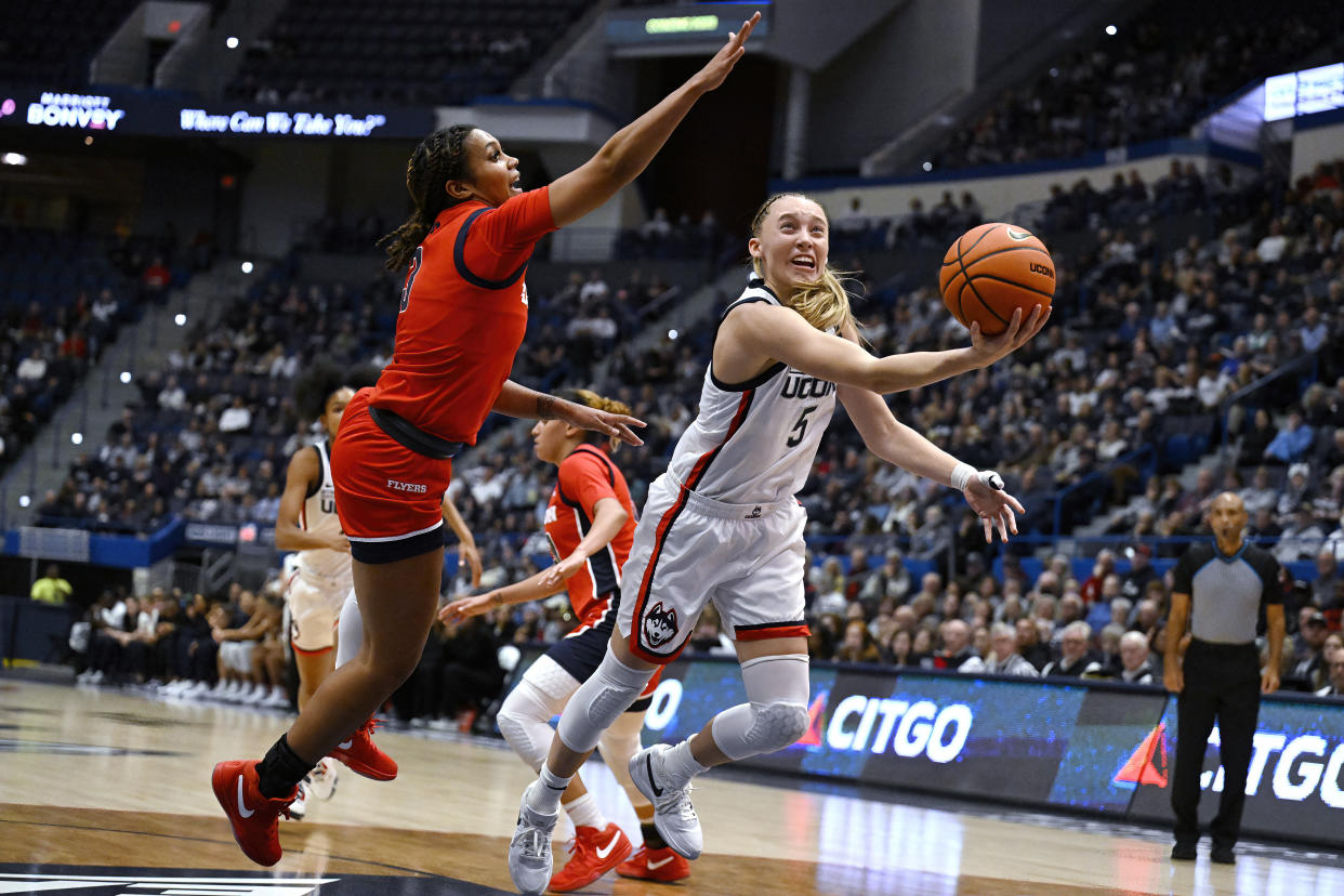 UConn guard Paige Bueckers shoots as Dayton guard Anyssa Jones defends in the first half of their season-opening game Wednesday. (AP Photo/Jessica Hill)