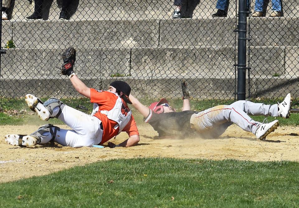 Durfee's Owen Moniz is tagged out at the plate by Diman catcher Byron Bell to end the game during the Diman Durfee game at Lafayette Park in Fall River Monday April 15 2024.