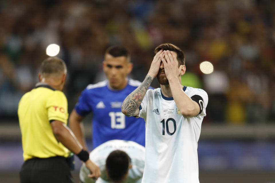 Argentina's Lionel Messi touches his face before scoring from a penalty spot against Paraguay during a Copa America Group B soccer match at the Mineirao stadium in Belo Horizonte, Brazil, Wednesday, June 19, 2019. (AP Photo/Natacha Pisarenko)