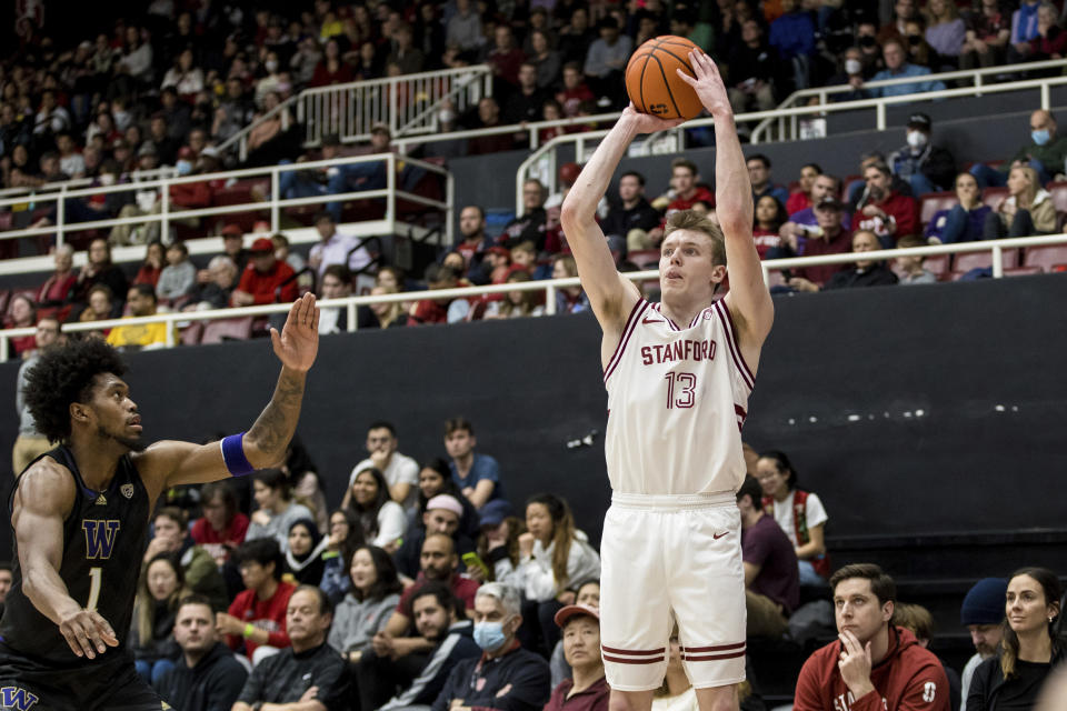 Stanford guard Michael Jones (13) takes a 3-point shot next to Washington forward Keion Brooks (1) during the first half of an NCAA college basketball game in Stanford, Calif., Sunday, Feb. 26, 2023. (AP Photo/John Hefti)