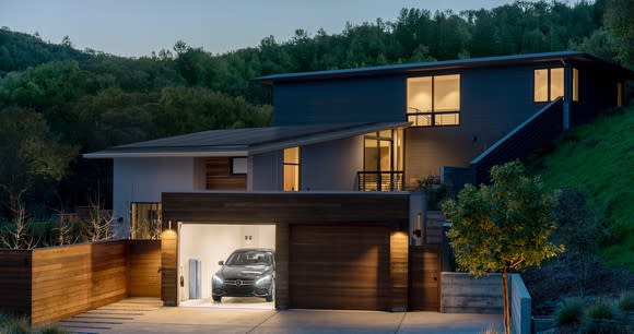 A house with a solar roof and an energy storage system in the garage.