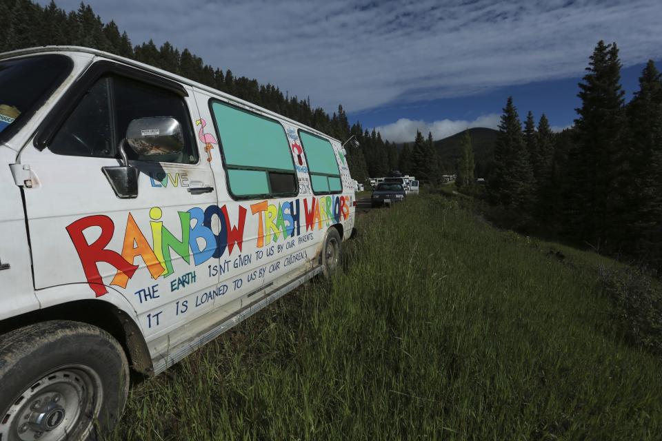 A van labeled "Rainbow Trash Warriors" sits at the entrance to the Rainbow Gathering on Friday, July 2, 2021, in the Carson National Forest, outside of Taos, N.M. More than 2,000 people have made the trek into the mountains of northern New Mexico as part of an annual counterculture gathering of the so-called Rainbow Family. While past congregations on national forest lands elsewhere have drawn as many as 20,000 people, this year’s festival appears to be more reserved. Members (AP Photo/Cedar Attanasio)