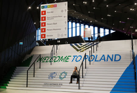 A man sits on the stairs of the event center during the COP24 UN Climate Change Conference 2018 in Katowice, Poland December, 15 2018. REUTERS/Kacper Pempel