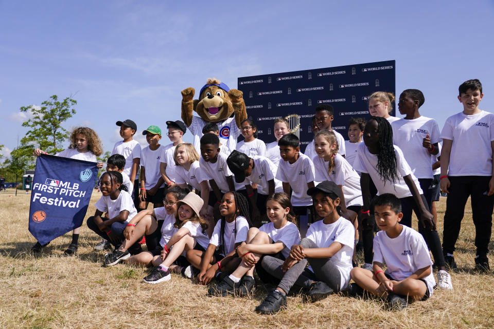 School kids at the MLB First Pitch Festival, at the Queen Elizabeth Olympic Park, in London, Thursday, June 22, 2023. Britain's relative success at the World Baseball Classic and the upcoming series between the Chicago Cubs and St. Louis Cardinals has increased London's interest about baseball. The sport's governing body says it has seen an uptick in interest among kids. (AP Photo/Alberto Pezzali)