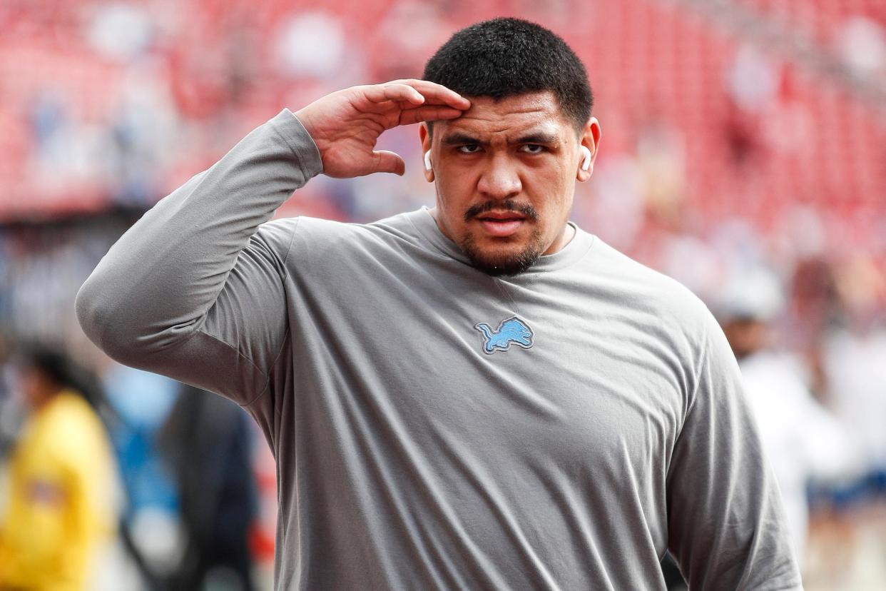 Detroit Lions offensive tackle Penei Sewell salutes fans during warms up before the NFC championship game against San Francisco 49ers at Levi's Stadium in Santa Clara, Calif. on Sunday, Jan. 28, 2024.