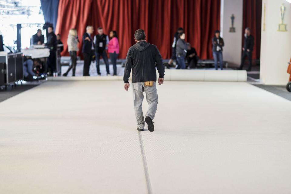 A man in the middle of a champagne-colored carpet