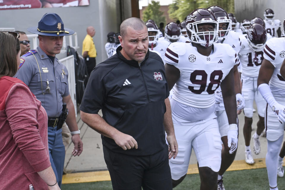 FILE - Mississippi State coach Zach Arnett walks onto the field with his team as they prepare to play Arkansas during an NCAA college football game Saturday, Oct. 21, 2023, in Fayetteville, Ark. Mississippi State fired coach Zach Arnett on Monday, Nov. 13, 2023, just 10 games into his first season on the job as the late Mike Leach's replacement. (AP Photo/Michael Woods, File)