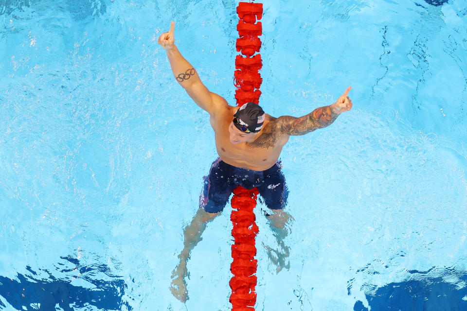 <p>TOKYO, JAPAN - JULY 29: Caeleb Dressel of Team United States celebrates after winning the gold medal and breaking the olympic record in the Men's 100m Freestyle Final on day six of the Tokyo 2020 Olympic Games at Tokyo Aquatics Centre on July 29, 2021 in Tokyo, Japan. (Photo by Rob Carr/Getty Images)</p> 