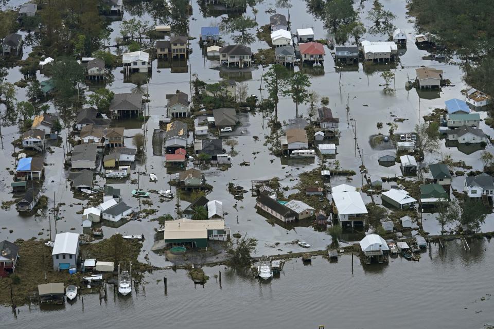 FILE - Floodwaters slowly recede in the aftermath of Hurricane Ida in Lafitte, La., Sept. 1, 2021. A new study says that back-to-back hurricanes that hit the same general place in the United States seem to be happening more often. (AP Photo/Gerald Herbert, File)