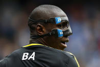 Chelsea's Demba Ba wears a protective mask during their English Premier League soccer match against Manchester City at The Etihad Stadium in Manchester, northern England, February 24, 2013. REUTERS/Darren Staples (BRITAIN - Tags: SPORT SOCCER TPX IMAGES OF THE DAY) FOR EDITORIAL USE ONLY. NOT FOR SALE FOR MARKETING OR ADVERTISING CAMPAIGNS. NO USE WITH UNAUTHORIZED AUDIO, VIDEO, DATA, FIXTURE LISTS, CLUB/LEAGUE LOGOS OR "LIVE" SERVICES. ONLINE IN-MATCH USE LIMITED TO 45 IMAGES, NO VIDEO EMULATION. NO USE IN BETTING, GAMES OR SINGLE CLUB/LEAGUE/PLAYER PUBLICATIONS - RTR3E7FJ