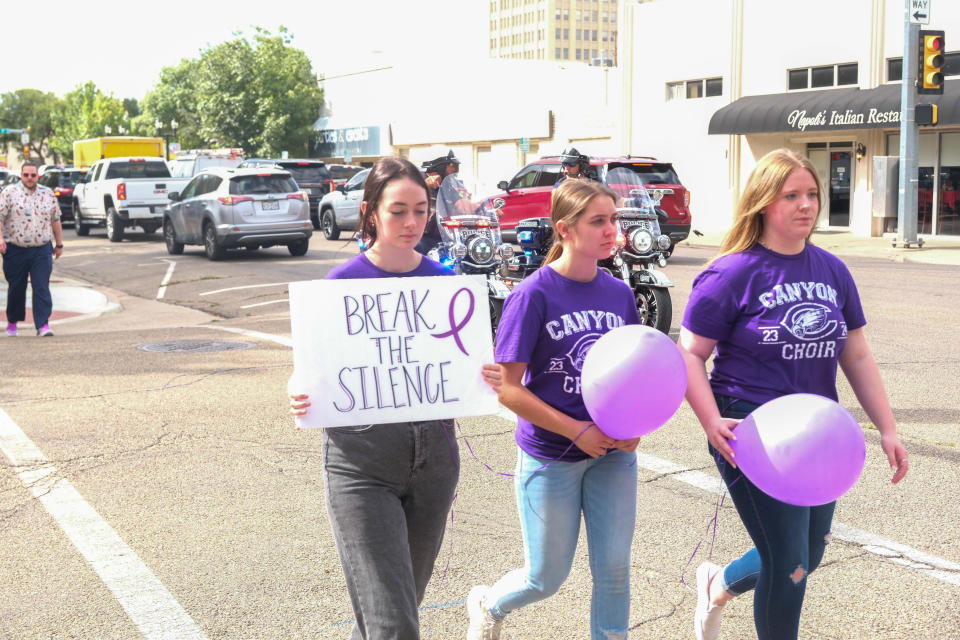 Canyon High School students join over 100 community members at the Community Walk Against Domestic Violence on Monday afternoon in downtown Amarillo.