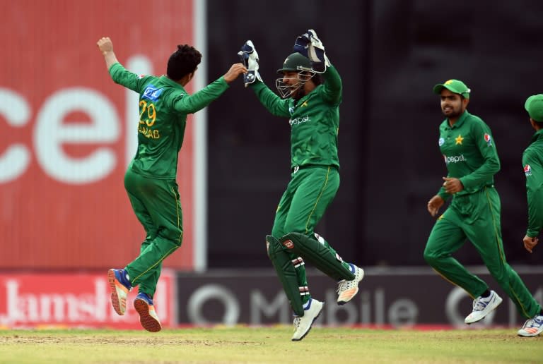 Pakistan's Shadab Khan (#29) celebrates with team captain/wicketkeeper Sarfraz Ahmed after bowling out West Indies' Rovman Powell (R) during the second of four-T20I-match between West Indies and Pakistan on March 30, 2017