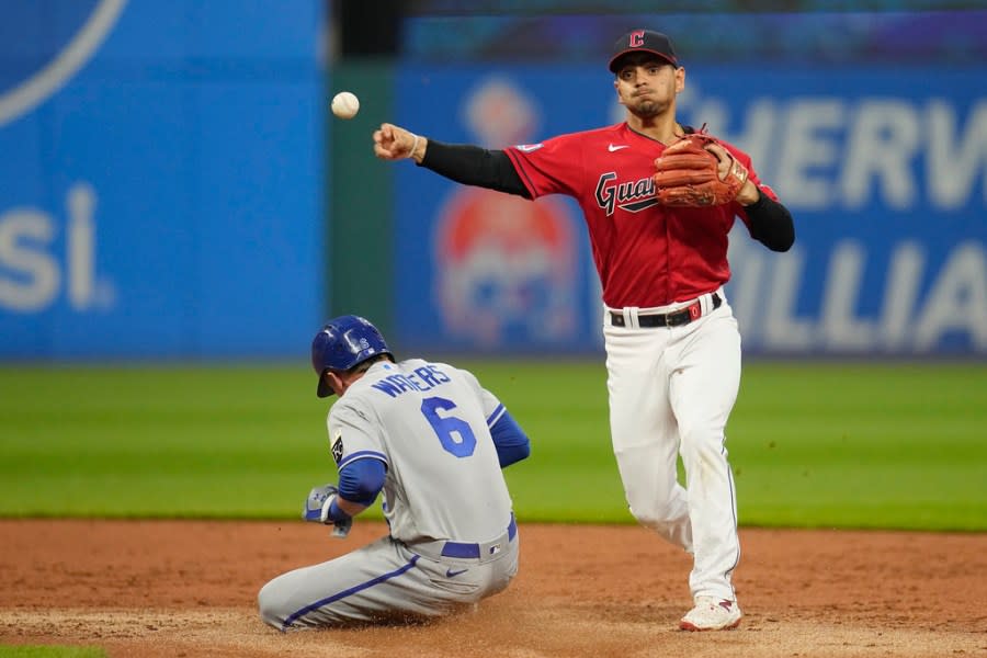 Cleveland Guardians second baseman Andres Gimenez throws to first base after forcing out Kansas City Royals’ Drew Waters (6) on a ball hit by Dairon Blanco, who was safe during the second inning of a baseball game Thursday, July 6, 2023, in Cleveland. (AP Photo/Sue Ogrocki)