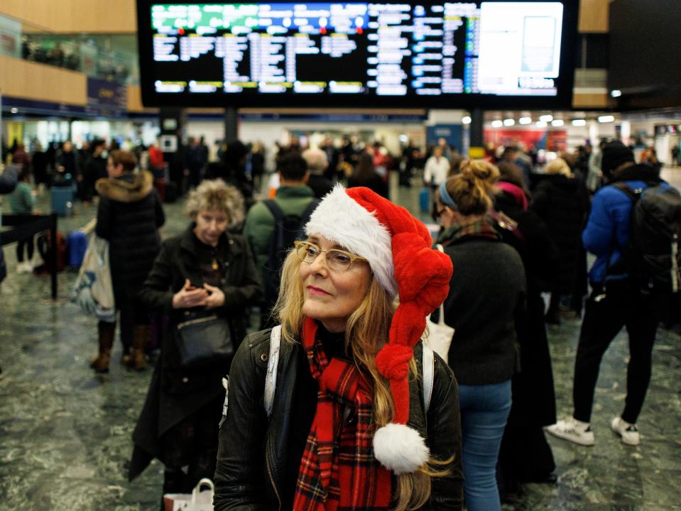 Passengers wait for train services to travel from Euston Station as they make their Christmas getaway in London (EPA)