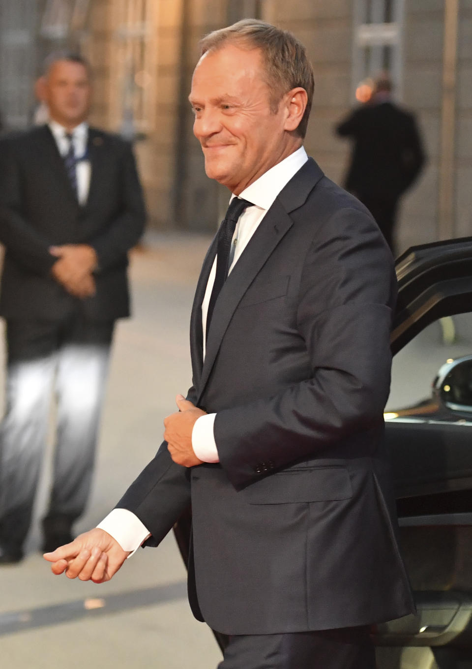 Donald Tusk, President of the European Council, smiles when arriving at the informal EU summit in Salzburg, Austria, Wednesday, Sept. 19, 2018. (AP Photo/Kerstin Joensson)