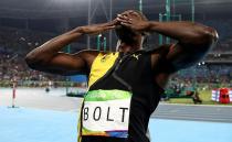 Bolt blows kisses to thousands of adoring fans after winning gold. Photo: Getty