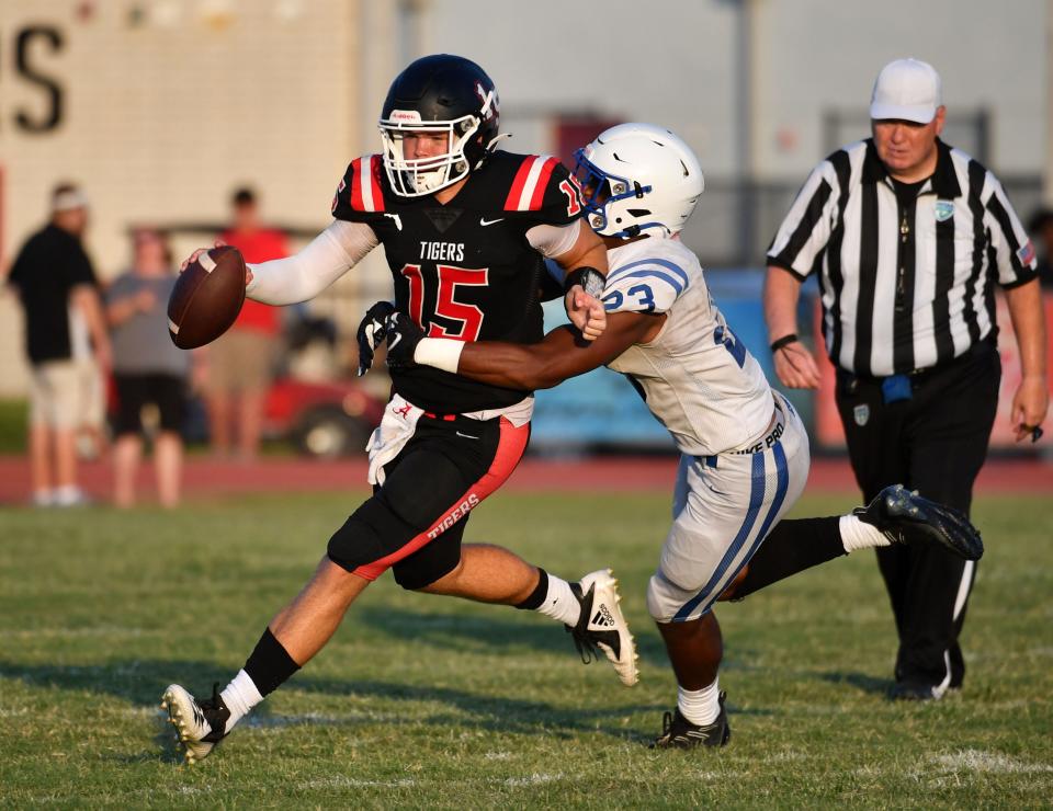 Palmetto High quarterback Zander Smith, #15, is brought down by Jesuit High defender Troy Bowles, #23. Palmetto High School hosted Jesuit High School (Tampa) in a spring football game Wednesday, May 18, 2022. 