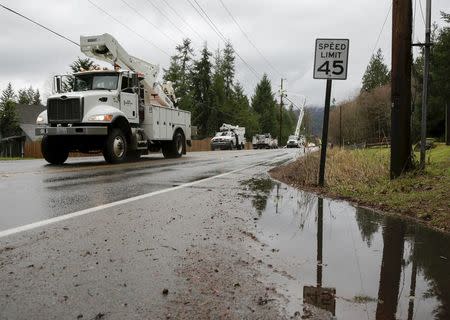 Utility trucks are pictured along Issaquah-Hobart Road Southeast as crews work to restore power lines in Issaquah, Washington December 10, 2015. REUTERS/Jason Redmond