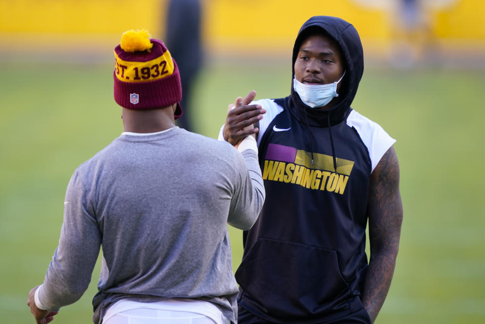 Washington Football Team quarterback Dwayne Haskins (7) greeting a teammate before the start of an NFL football game against the Carolina Panthers, Sunday, Dec. 27, 2020, in Landover, Md. (AP Photo/Susan Walsh)