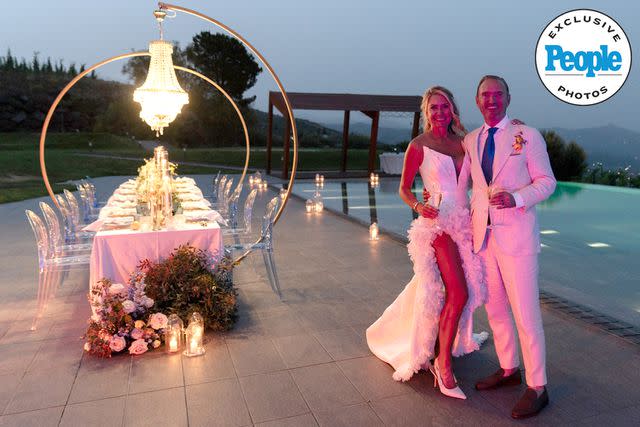 <p>Linda Puccio</p> Kary Brittingham and Mark A. Anderson take a picture at their wedding reception