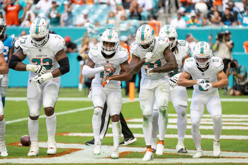 Miami Dolphins running back Raheem Mostert (31) celebrates scoring a touchdown with Miami Dolphins offensive lineman Austin Jackson (73), Miami Dolphins wide receiver Jaylen Waddle (17), Miami Dolphins offensive lineman Robert Hunt (68) and Miami Dolphins wide receiver Braxton Berrios (0) as they dance in the end zone during an NFL football game against the Carolina Panthers, Sunday, Oct. 15, 2023, in Miami Gardens, Fla. (AP Photo/Doug Murray)