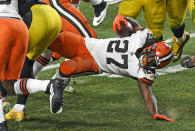 Cleveland Browns running back Kareem Hunt (27) is tackled during the second half of an NFL wild-card playoff football game against the Pittsburgh Steelers in Pittsburgh, late Sunday, Jan. 10, 2021. The Browns won 48-37.(AP Photo/Don Wright)