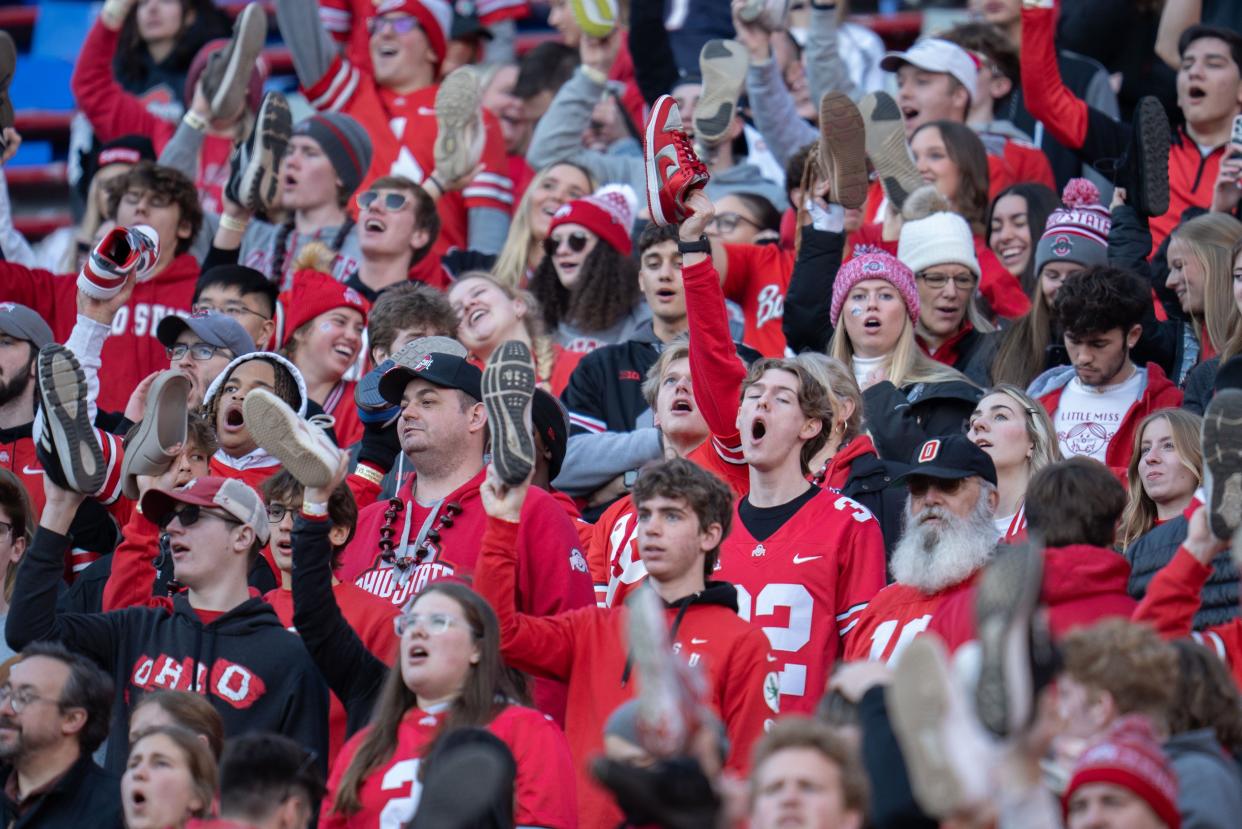 Nov 18, 2023; Columbus, Ohio, USA; 
Ohio State Buckeyes fans cheer with their shoes on their hands during the first half of their game against Minnesota Golden Gophers on Saturday, Nov. 18, 2023 at Ohio Stadium.