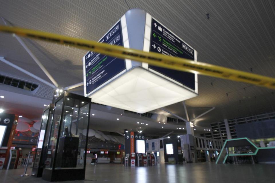 Tape blocks the entrance to the main hall of Kuala Lumpur International Airport 2 for the decontamination process in Sepang, Malaysia on Sunday, Feb. 26, 2017. Malaysian police ordered a sweep of Kuala Lumpur airport for toxic chemicals and other hazardous substances following the killing of Kim Jong Nam. (AP Photo/Daniel Chan)