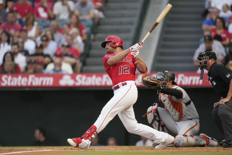 Los Angeles Angels' Hunter Renfroe (12) doubles during the first inning of a baseball game against the San Francisco Giants in Anaheim, Calif., Tuesday, Aug. 8, 2023. Brandon Drury and Mike Moustakas scored. (AP Photo/Ashley Landis)