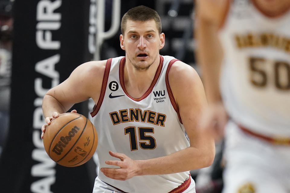 Denver Nuggets center Nikola Jokic (15) brings the ball up court during the first half of an NBA basketball game against the Utah Jazz, Saturday, April 8, 2023, in Salt Lake City. (AP Photo/Rick Bowmer)