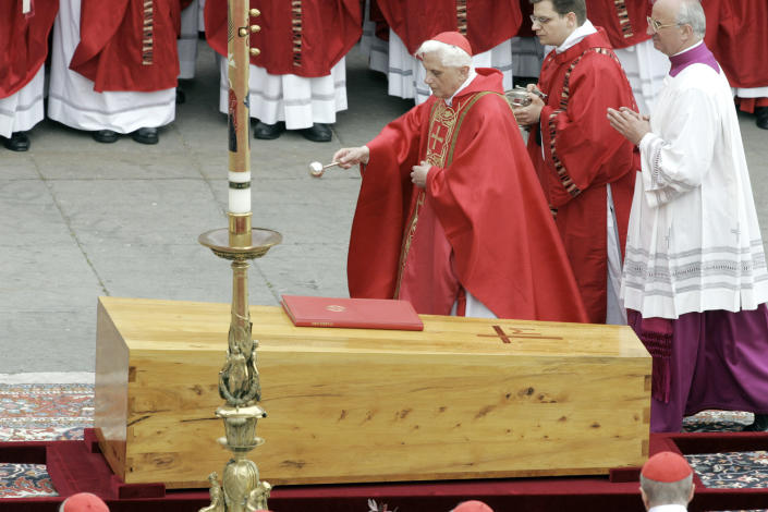 FILE - Cardinal Joseph Ratzinger blesses the coffin containing the body of Pope John Paul II during the funeral mass in St. Peter's Square at the Vatican on April 8, 2005. Ratzinger went on to become Pope Benedict XVI. Pope Emeritus Benedict XVI, the German theologian who will be remembered as the first pope in 600 years to resign, has died, the Vatican announced Saturday. He was 95. (AP Photo/Andrew Medichini, File)