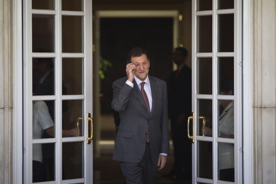 Spain's Prime Minister Mariano Rajoy, adjust his glasses before a meeting with Netherlands' Prime Minister Mark Rutte at the Moncloa Palace, in Madrid, Thursday, June 7, 2012. Spain's Prime Minister appeared Thursday to have abandoned his insistence that the country's troubled banking sector will not need an external bailout, as for the first time he avoided ruling out such an option.(AP Photo/Daniel Ochoa de Olza)