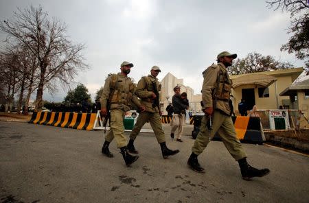 FILE PHOTO: Paramilitary soldiers walk past the Supreme Court building in Islamabad, Pakistan January 16, 2012. REUTERS/Faisal Mahmood/File Photo