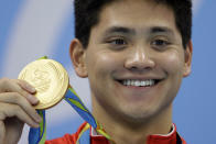 FILE - Singapore's Joseph Schooling shows off his gold medal in the men's 100-meter butterfly medals ceremony during the swimming competitions at the 2016 Summer Olympics, Friday, Aug. 12, 2016, in Rio de Janeiro, Brazil. Schooling, who beat Michael Phelps in the 100-meter butterfly to win Singapore's first and only Olympic gold medal at Rio de Janeiro in 2016, announced his retirement, Tuesday, April 2, 2024. (AP Photo/Michael Sohn, File)