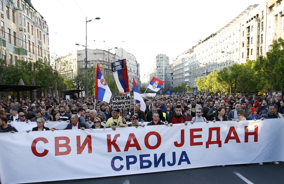 People hold a banner that reads: ''All as one - Serbia'' during a protest march against president Aleksandar Vucic in Belgrade, Serbia, Saturday, April 20, 2019. Thousands of people have rallied in Serbia's capital for 20th week in a row against populist President Aleksandar Vucic and his government. (AP Photo/Darko Vojinovic)