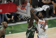 Phoenix Suns' Deandre Ayton (22) shoots against Milwaukee Bucks' Jrue Holiday (21) during the first half of Game 3 of basketball's NBA Finals, Sunday, July 11, 2021, in Milwaukee. (AP Photo/Aaron Gash)