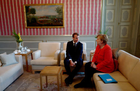 German Chancellor Angela Merkel and French President Emmanuel Macron attend a bilateral meeting at the German government guesthouse Meseberg Palace in Meseberg, Germany, June 19, 2018. John MacDougall/Pool via REUTERS