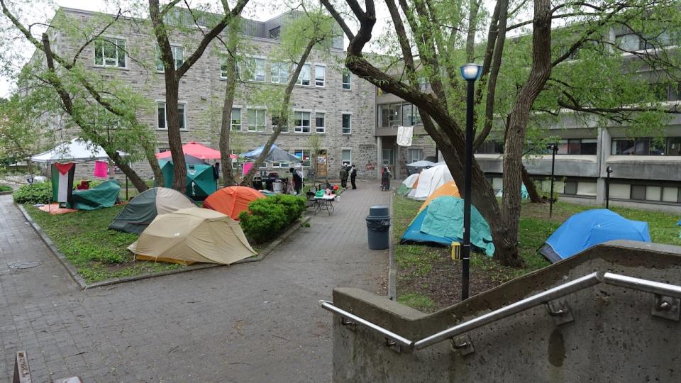 The encampment at Queen's University was set up over the weekend and includes more than a dozen tents and canopies.