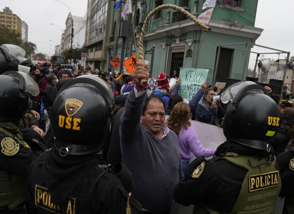 Demonstrators gather outside a court building to show support for Yenifer Paredes, the sister-in-law of Peru´s President Pedro Castillo, in Lima, Peru, Sunday, Aug. 28, 2022. A judge will decide if Paredes should be held in preventive detention for 36 months, as requested by the prosecution for her alleged participation in a corruption network. (AP Photo/Martin Mejia)