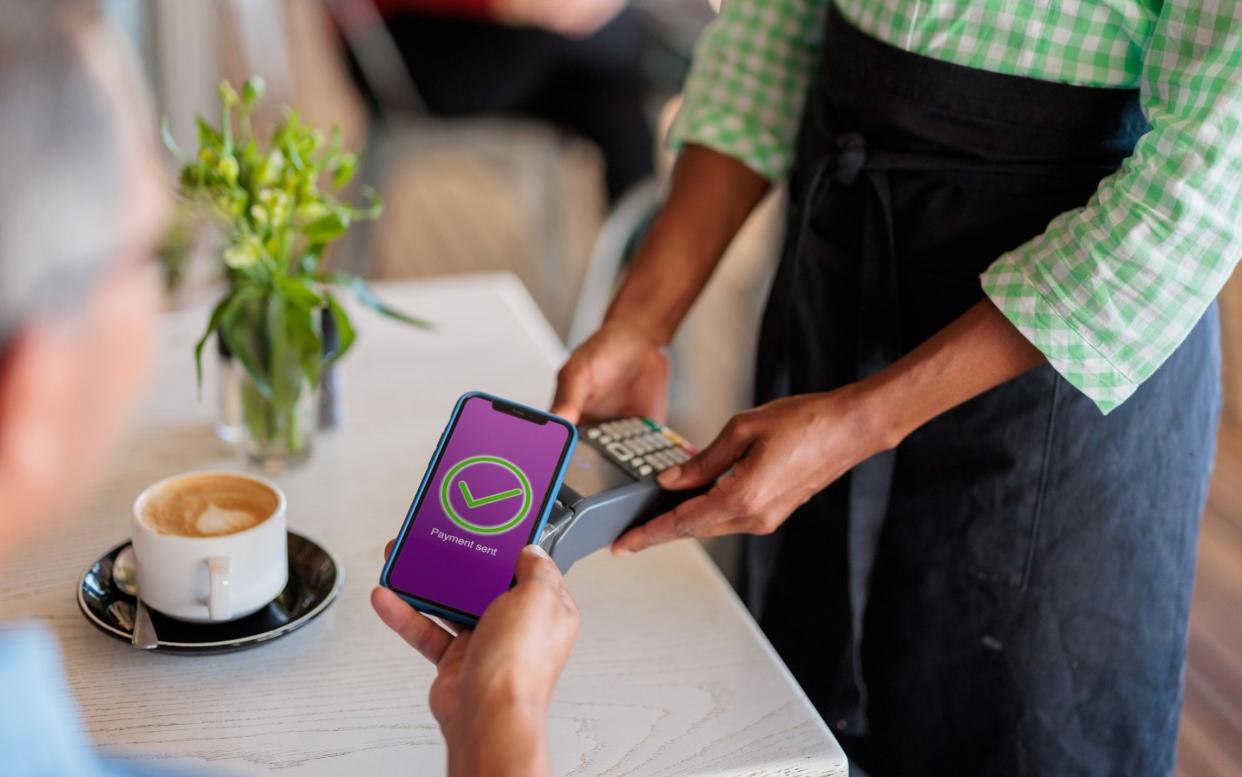 Customer paying for his coffee via a banking app