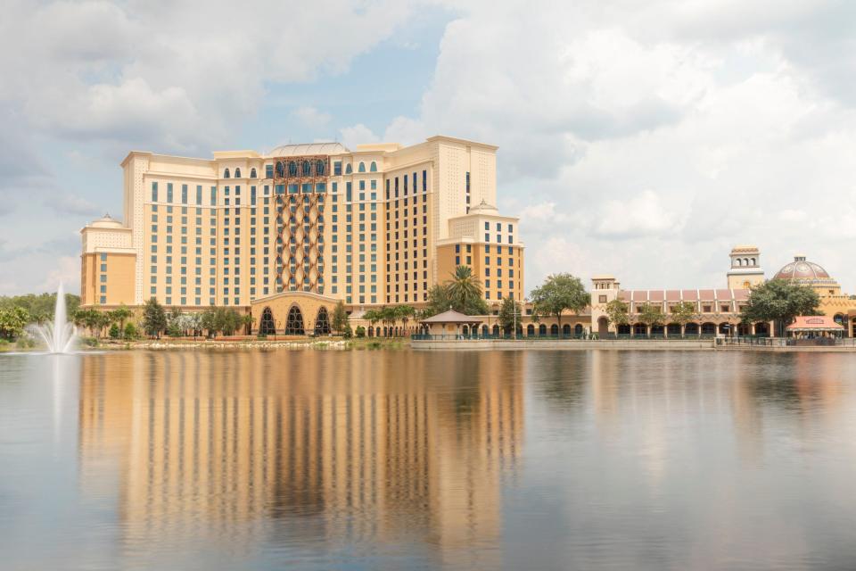 Gran Destino Tower is reflected in the water at Disney's Coronado Springs Resort.