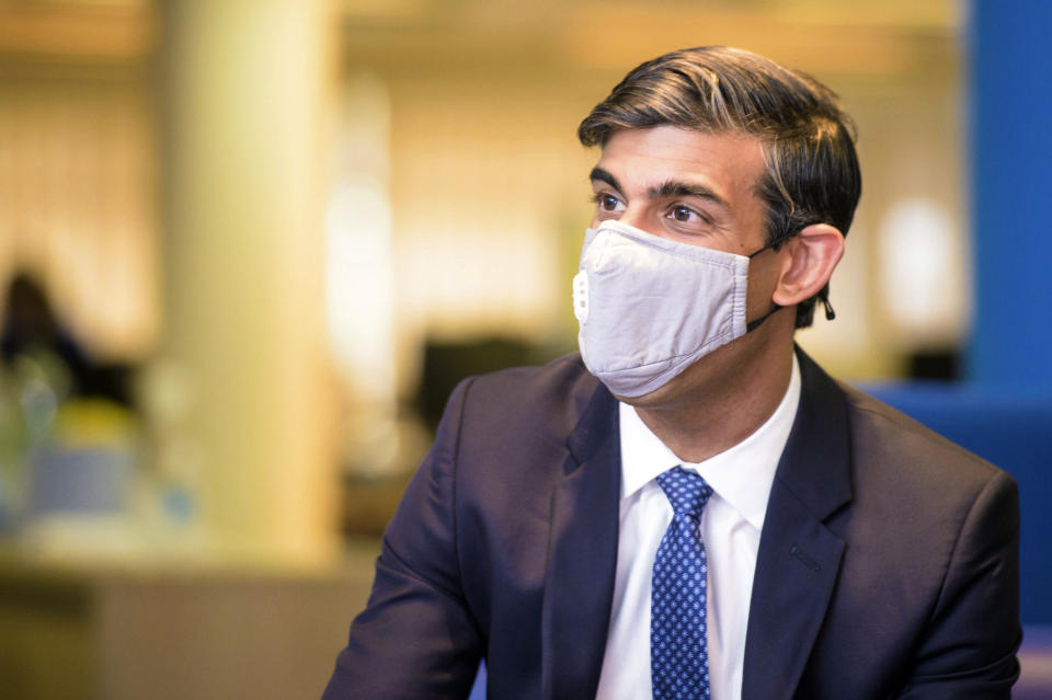 Britain's Chancellor of Exchequer Rishi Sunak wearing a face mask visits the Jobcentre Plus in east London, Thursday July 16, 2020, to see the new support being provided in job centres, as part of the Government’s Plan for Jobs. (Anthony Upton/Pool via AP)