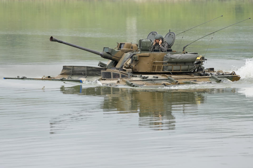 South Korea's K21 infantry fighting vehicle sails to shores in a smoke during the combined wet gap crossing military drill between South Korea and the United States as a part of the Ulchi Freedom Shield military exercise in Cheorwon, South Korea, Thursday, Aug. 31, 2023. (AP Photo/Lee Jin-man)