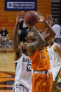 Oklahoma State guard Avery Anderson III (0) shoots in front of Baylor guard Jared Butler (12) in the second half of an NCAA college basketball game Saturday, Jan. 23, 2021, in Stillwater, Okla. (AP Photo/Sue Ogrocki)