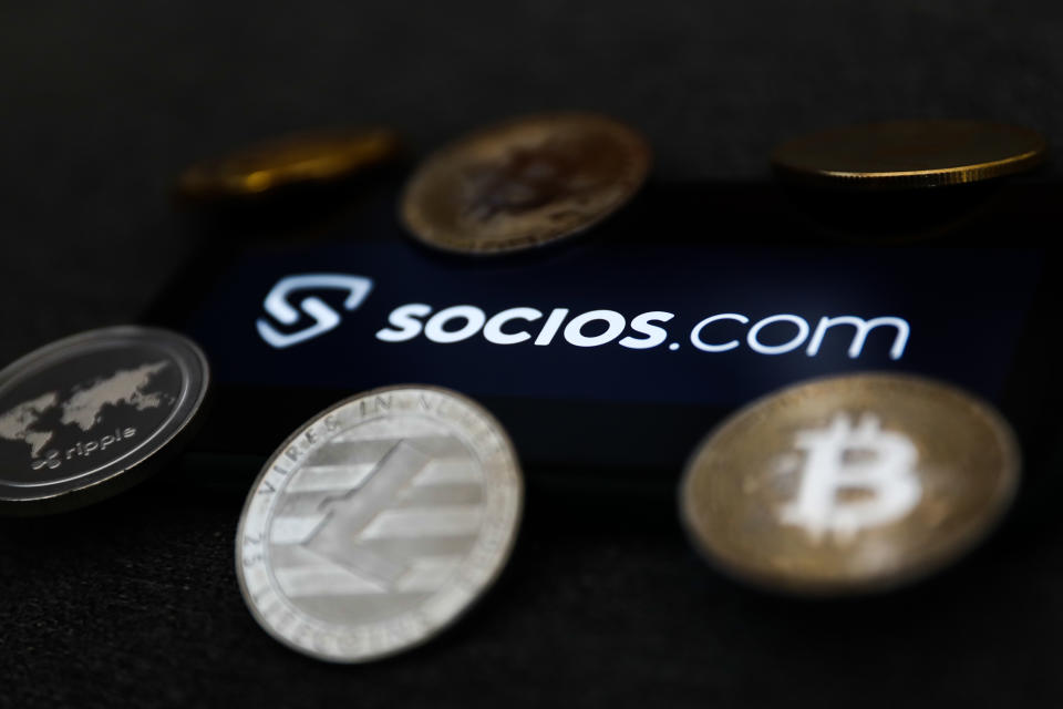 Socios.com logo displayed on a phone screen and representation of cryptocurrency are seen in this illustration photo taken in Krakow, Poland on February 16, 2022. (Photo: Jakub Porzycki/NurPhoto via Getty Images)