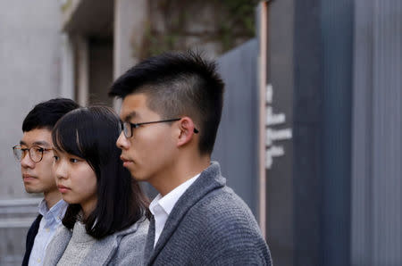 Disqualified lawmaker Nathan Law, and student activists Agnes Chow and Joshua Wong (L-R) speak to media outside Central Government Offices in Hong Kong, China December 27, 2017. REUTERS/Tyrone Siu